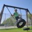 Kid playing on double tyre swing