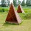 Tipi Nature puidust mänguväljak element aias rohelise muru peal.